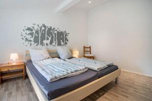 a bedroom with a bed with blue sheets on it at Wohnung Obergeschoss in Funfseen