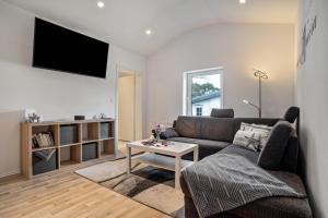 a living room with a couch and a table at Wohnung Obergeschoss in Funfseen