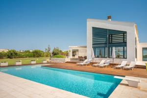 a villa with a swimming pool and a house at Villa Canutells Ref 27 in Mahón