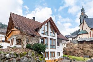 a white house with a brown roof at Ferienwohnung Matt in Todtmoos