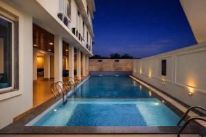 a swimming pool in the middle of a building at night at The Colonial - A Lake View Hotel in Udaipur in Udaipur