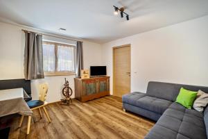a living room with a couch and a table at Krämerhof Apt Peitlerkofel in Rodengo