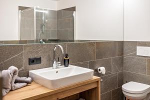 a bathroom with a sink and a toilet at Krämerhof Apt Peitlerkofel in Rodengo +18 photos
