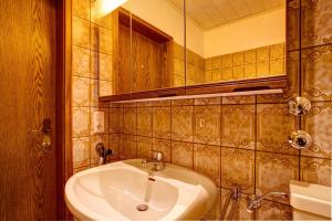 a bathroom with a sink and a mirror at Haus Zur Laterne in Willingen +67 photos