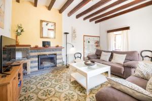 a living room with a couch and a fireplace at Villa Rae in Sóller