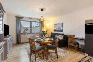 a kitchen and living room with a table and chairs at Marla in Lauterbach