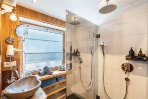 a bathroom with a sink and a shower at Chalet Bergliebe mit Zirbenholz in Inzell +19 photos