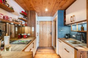 a kitchen with wooden cabinets and wooden floors at Chalet Bergliebe mit Zirbenholz in Inzell