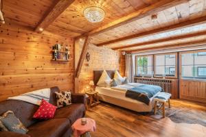 a bedroom with a bed and a couch in a room at Chalet Bergliebe mit Zirbenholz in Inzell