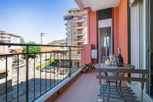 a balcony with a table and a view of a street at Iris Apartment Lago Maggiore in Angera