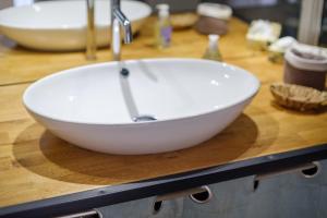 a white bowl sink on a counter in a bathroom at Appartement Vaugrenier Presidences in Villeneuve-Loubet +15 photos