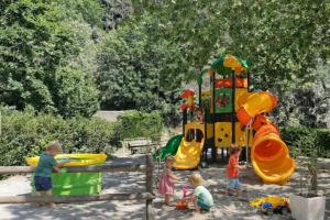 a group of children playing in a playground at Camping de Retourtour in Lamastre