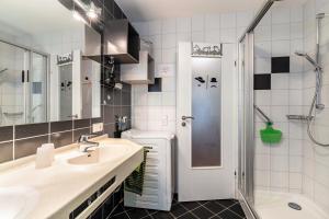 a bathroom with a sink and a shower at Haus Ursula in Ettenheim +47 photos