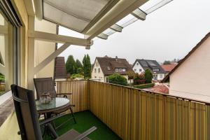 a patio with a table and chairs on a balcony at Haus Ursula in Ettenheim