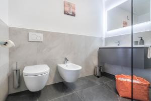 a bathroom with a toilet and a sink at Trojer Apartment 2 in Sarntal +19 photos