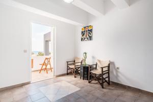 a dining room with a table and chairs and a window at White Pearl in Lachania