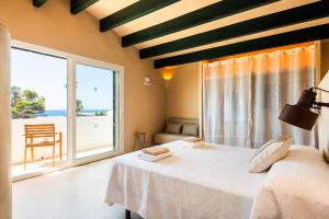 a bedroom with a bed and a large window at Binimadi in Binisafua +23 photos