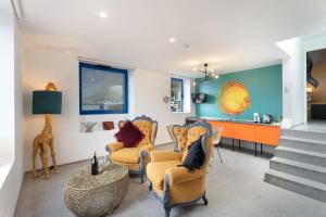 a living room with yellow chairs and a table at Apartamentos Puntagrande in Frontera