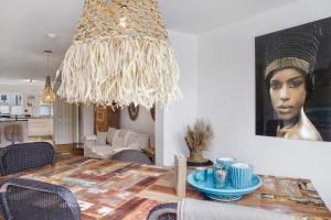 a living room with a table and a painting of a woman at Lieblingsplatz Ferienwohnung in Bad Tölz