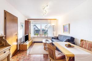 a living room with a couch and a dining room table at Ferienoase Balve in Balve