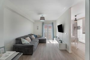 a white living room with a couch and a table at Casa el Jable in Guía de Isora