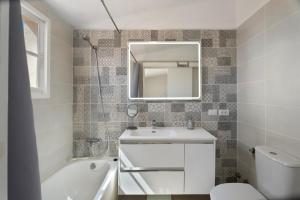 a bathroom with a sink and a toilet and a mirror at Casa el Jable in Guía de Isora +22 photos