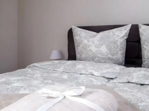 a white bed with a white bow on it at Kuckucks in Ibach +23 photos