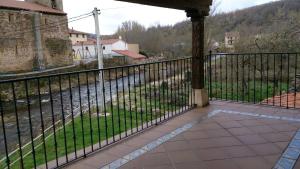 a balcony with a fence and a view of a river at El Mirador Del Pedroso in Barbadillo del Pez