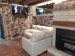 a living room with a couch and a fireplace at El Mirador Del Pedroso in Barbadillo del Pez +12 photos