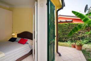 a bedroom with a bed and a open door at Villa Pairola - in San Bartolomeo al Mare