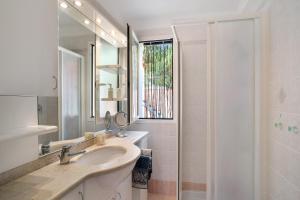 a bathroom with a sink and a mirror and a shower at Villa Pairola - in San Bartolomeo al Mare