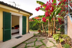 a room with a bed and some trees and flowers at Villa Pairola - in San Bartolomeo al Mare