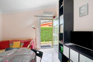 a room with a living room with a tv and a couch at Villa Pairola - in San Bartolomeo al Mare +15 photos