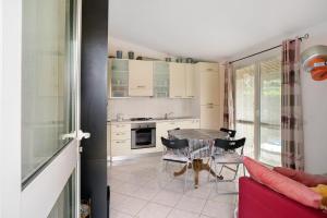 a kitchen with a table and chairs in a room at Villa Pairola - in San Bartolomeo al Mare