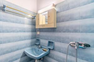 a blue bathroom with a sink and a shower at Mires House Side First Floor 9 in Agios Gordios +20 photos