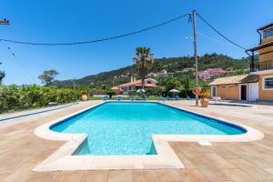 a swimming pool at a villa with a mountain in the background at Mires House Side First Floor 9 in Agios Gordios