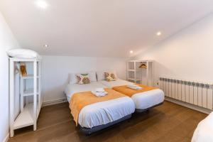 a white bedroom with a bed and a ladder at El Arrebol Rural in El Espinar +37 photos