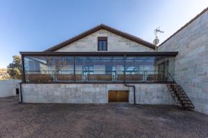 a large building with a balcony on the side of it at El Arrebol Rural in El Espinar