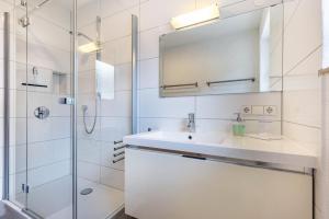 a bathroom with a sink and a shower at Ferienwohnung Lammerberg in Albstadt +27 photos