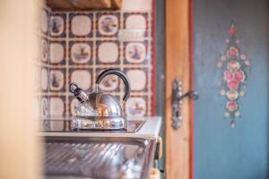 a tea kettle is sitting on top of an oven at Ferienhaus Moarbach in Floronzo
