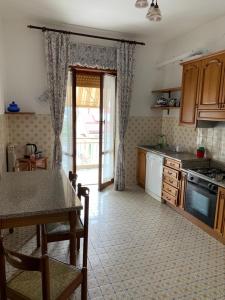 a kitchen with a table and a dining room at Serravalle Shopping - Outlet in Serravalle Scrivia