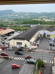 a parking lot with cars parked in front of a building at Serravalle Shopping - Outlet in Serravalle Scrivia