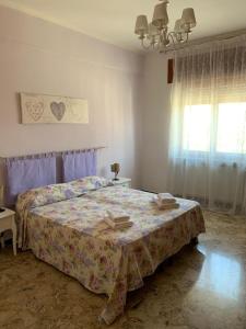 a bedroom with a bed and a window at Serravalle Shopping - Outlet in Serravalle Scrivia