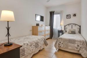 a bedroom with two beds and a dresser at El Cortijo in La Oliva +32 photos