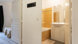 a bathroom with a sink and a bath tub at Virginia N104 - ST2 in Grasse