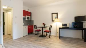 a small kitchen with a table and chairs in a room at Virginia N104 - ST2 in Grasse