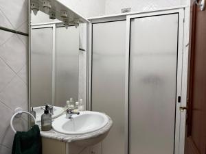 a bathroom with a sink and a shower at Casa do Sossego in Safara +36 photos