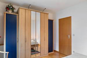 a bedroom with wooden wardrobes with a mirror at Ferienwohnung Tannenblick 3-1 in Oberhof
