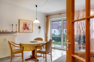 a dining room with a table and chairs and a window at Ferienwohnung Tannenblick 3-1 in Oberhof