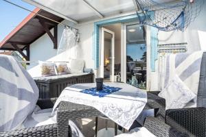 a patio with a table and chairs on a porch at Ostseeblick in Kröslin